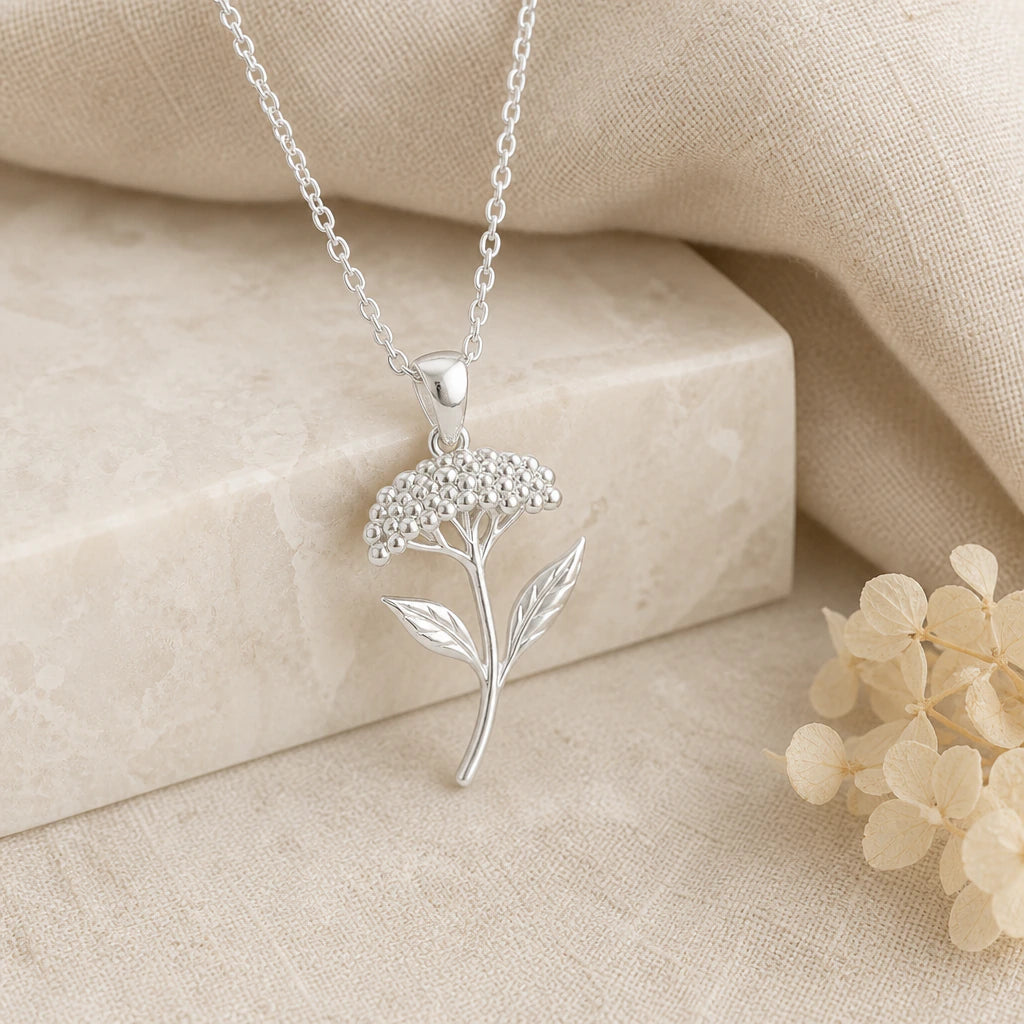 925 sterling silver yarrow flower pendant necklace on softly folded cream linen