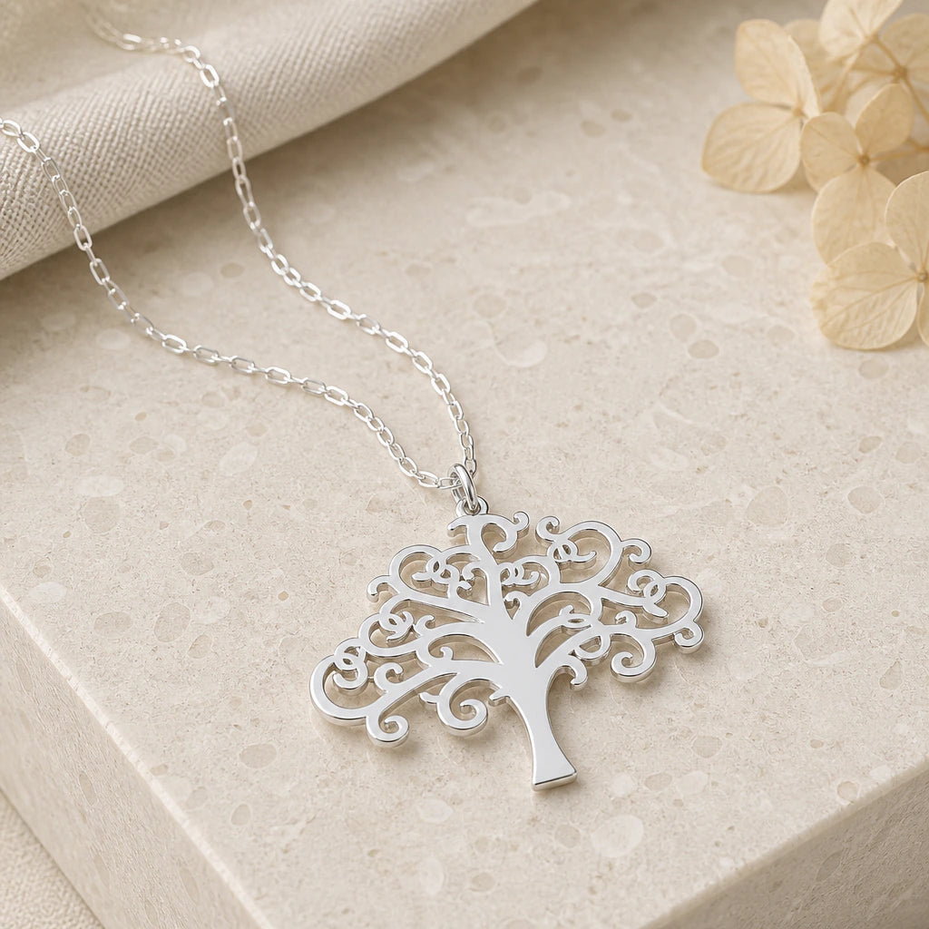 Close-up of silver swirling tree of life pendant showing the sculpted detail