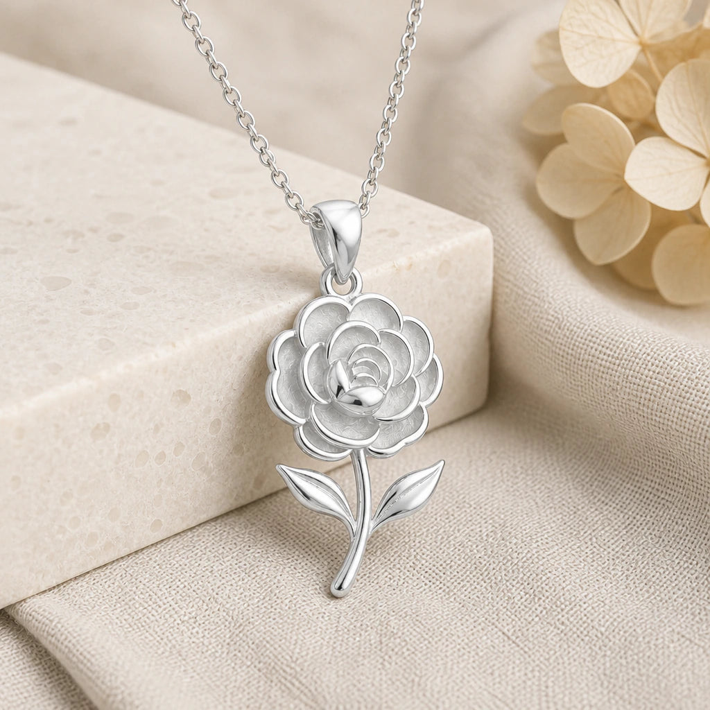 925 sterling silver camellia flower pendant necklace on softly folded cream linen