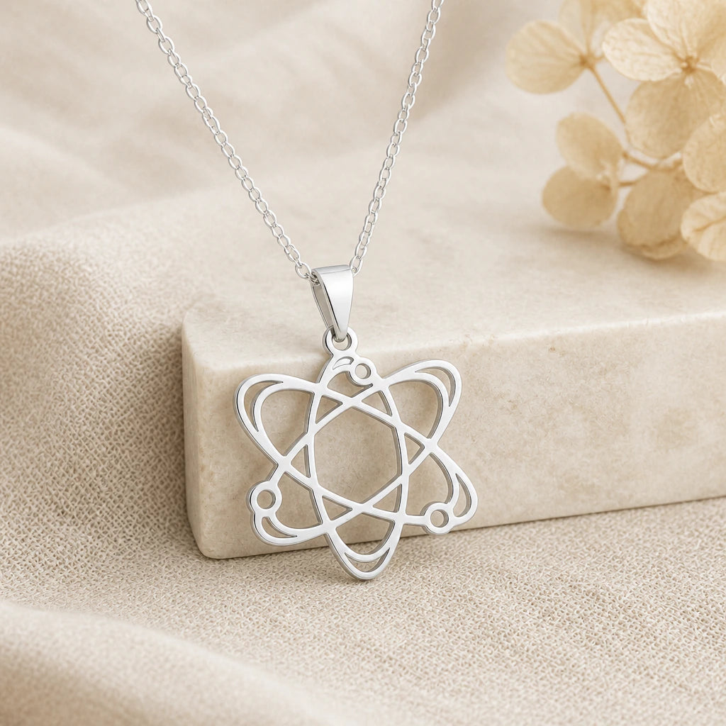 925 sterling silver atom pendant necklace on softly folded cream linen