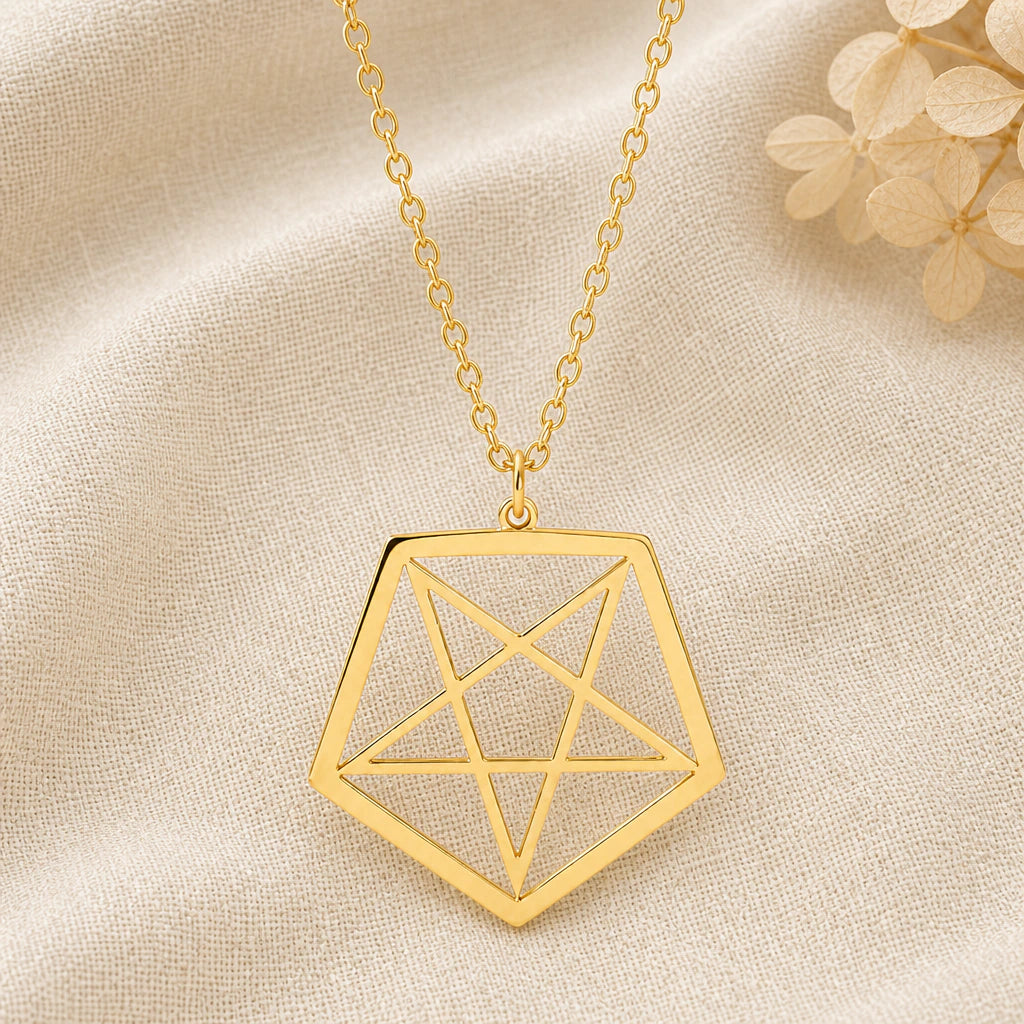 Inverted Pentagram pendant necklace in a warm gold finish on cream fabric