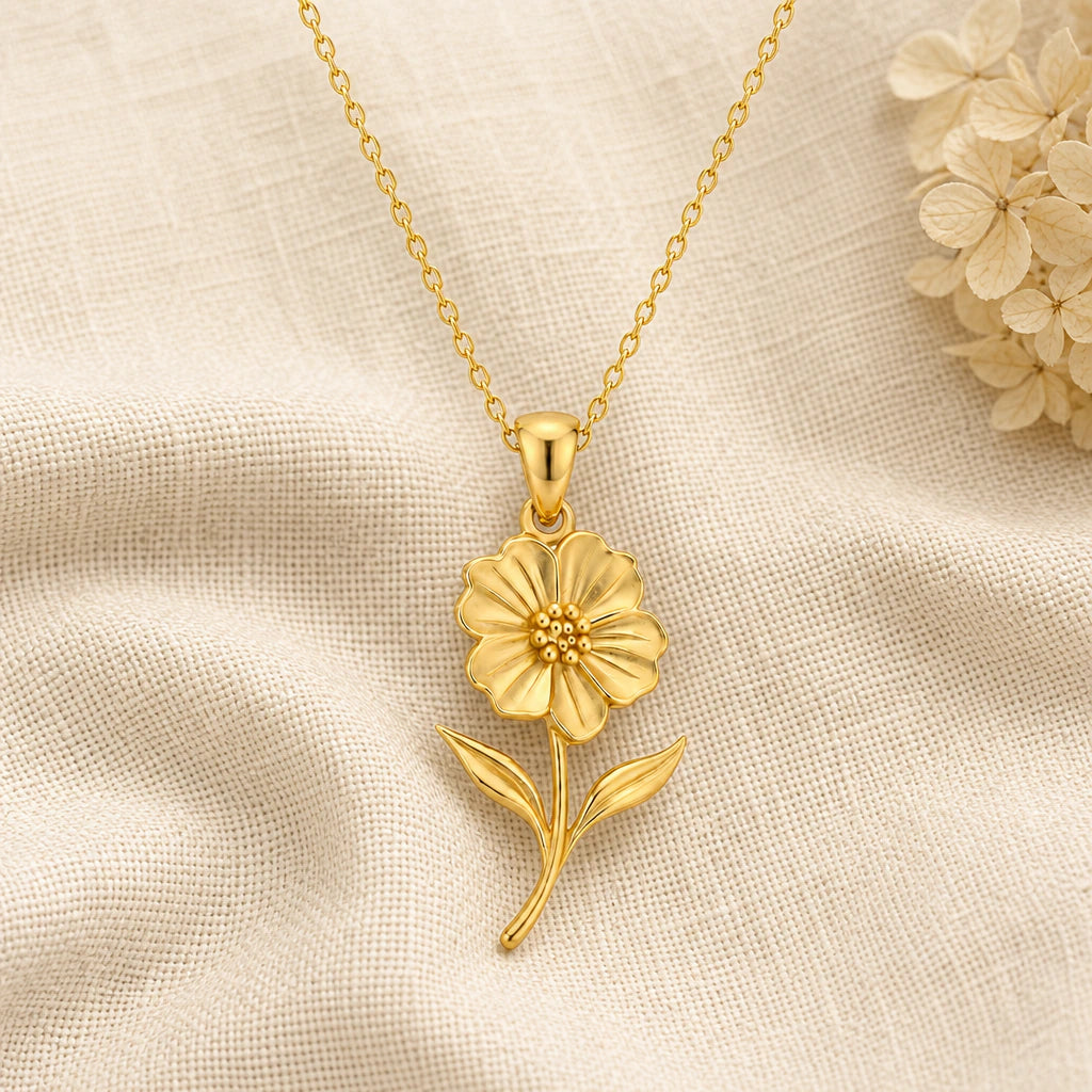 Petunia Flower pendant necklace in a warm gold finish on cream fabric