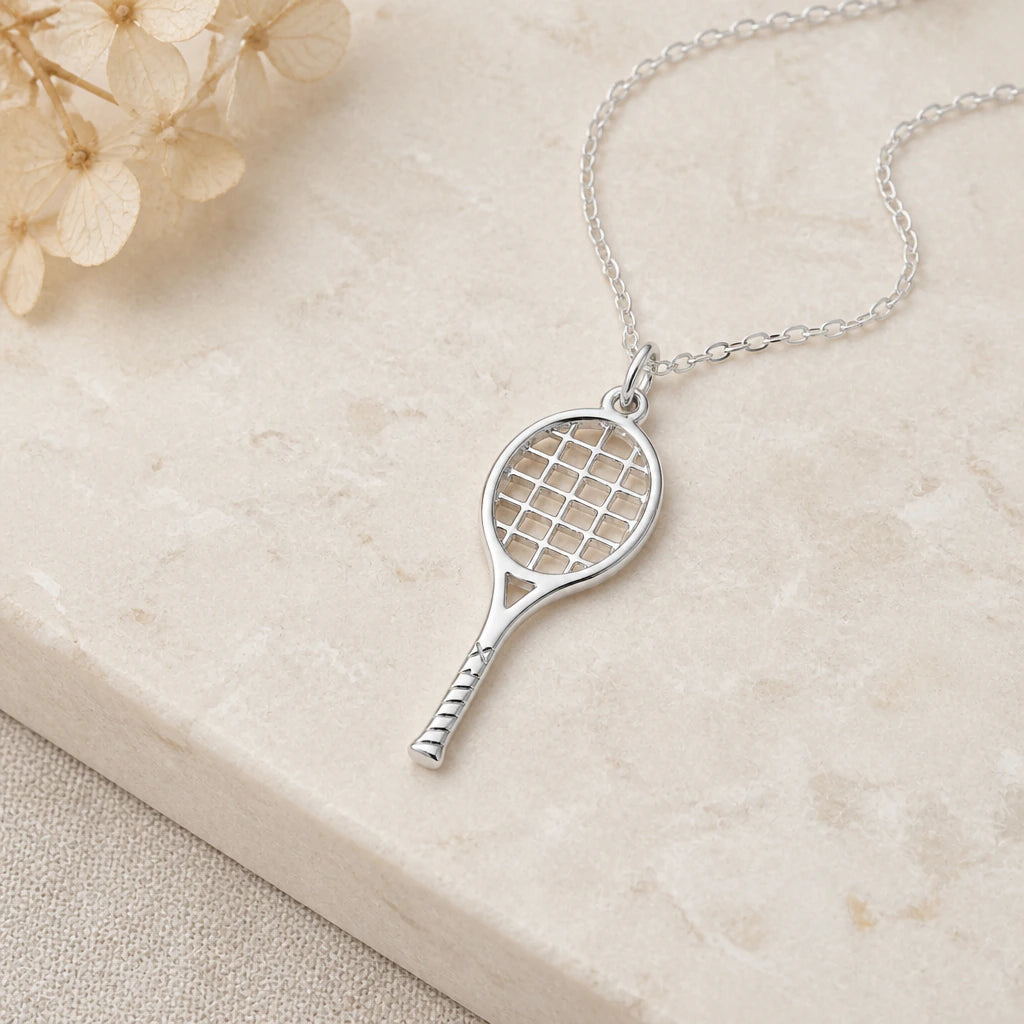 Close-up of silver tennis racket pendant showing the sculpted detail