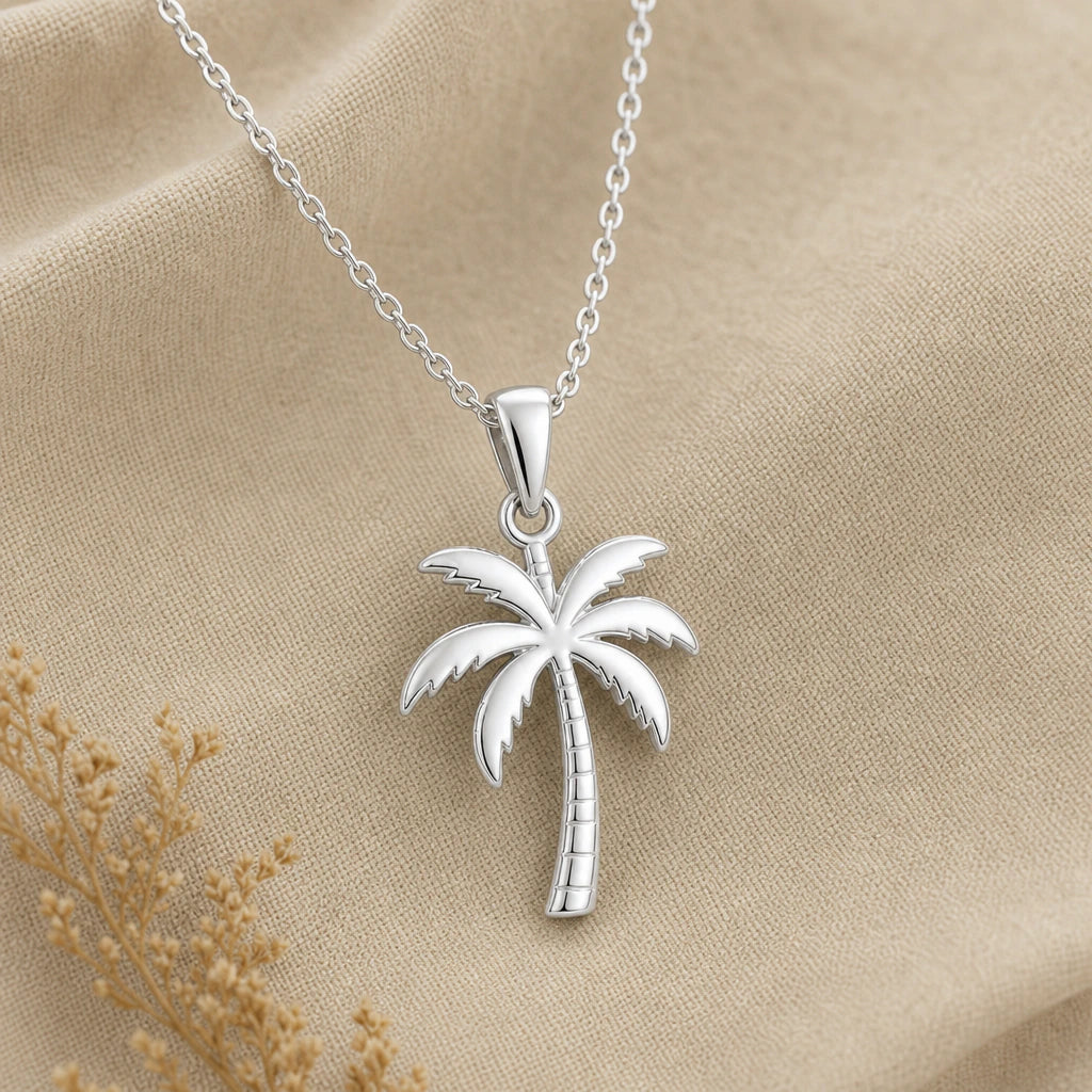 Close-up of silver palm tree pendant with polished fronds and ringed trunk