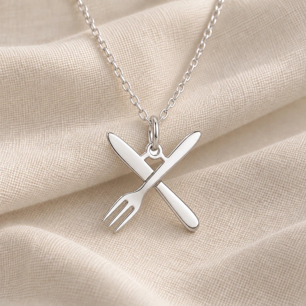 925 sterling silver chef fork and knife pendant necklace on cream fabric