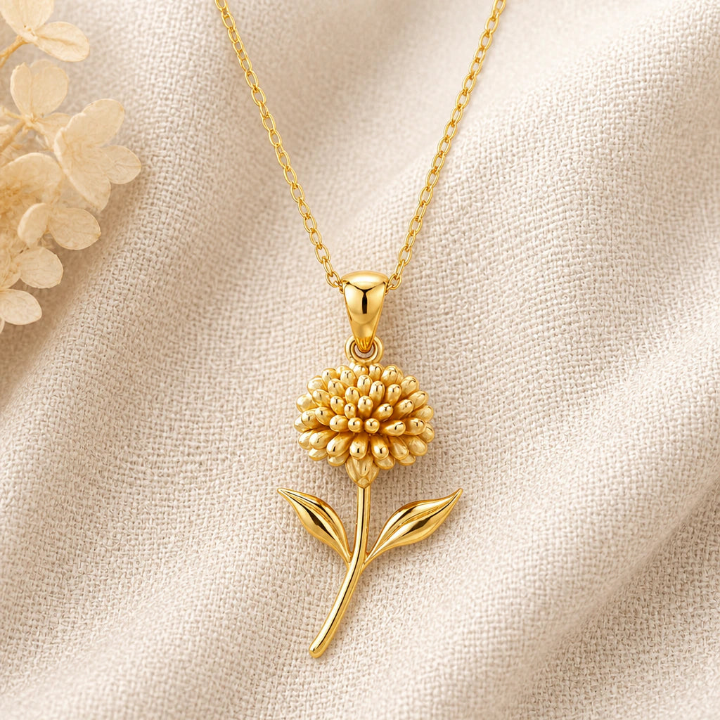 Sedum Flower pendant necklace in a warm gold finish on cream fabric