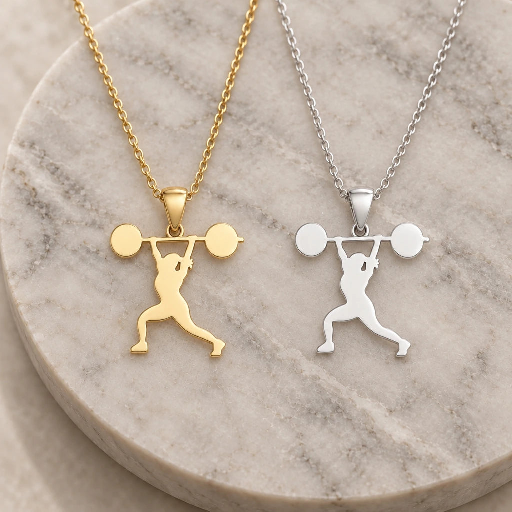 Weightlifter Overhead Press pendant necklace in silver and gold finishes side by side