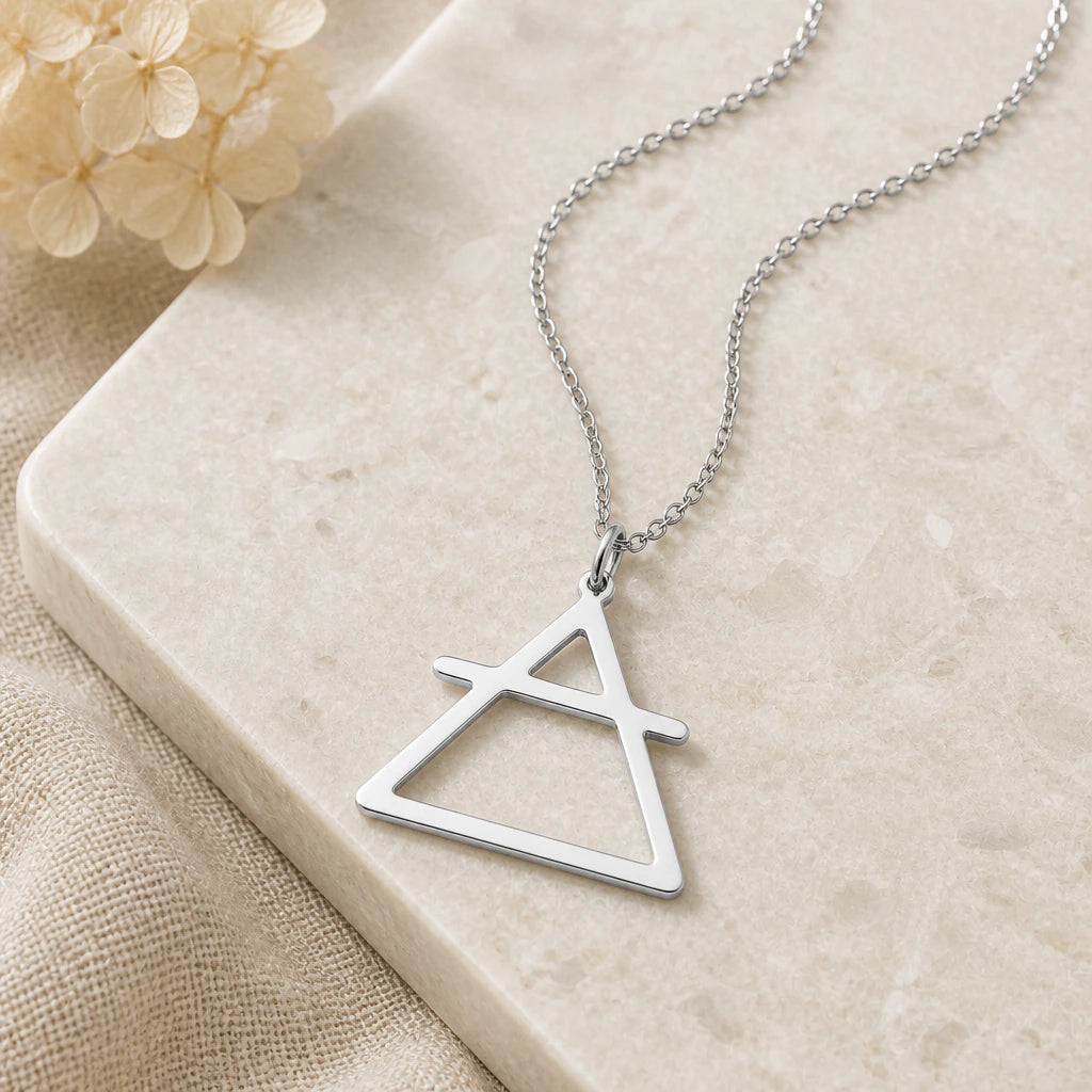 Close-up of silver air element pendant showing the sculpted detail