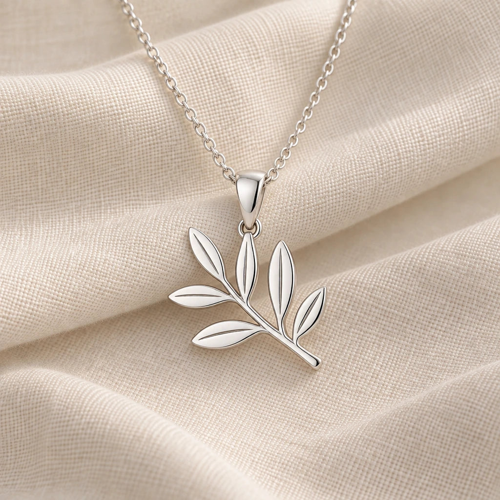 925 sterling silver olive branch pendant necklace on cream fabric