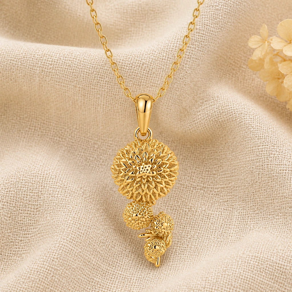 Chrysanthemum Flower pendant necklace in a warm gold finish on cream fabric