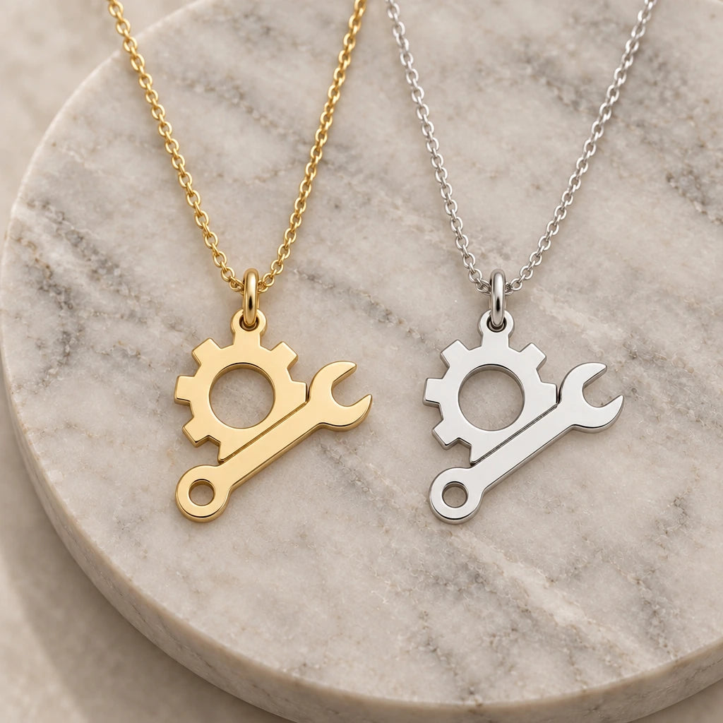 Engineer Gear and Spanner pendant necklace in silver and gold finishes side by side