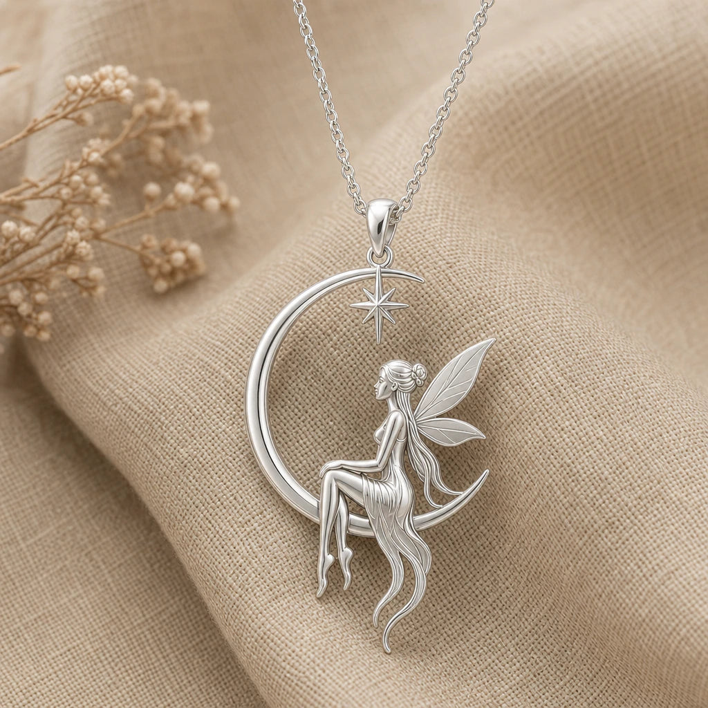 Close-up of silver fairy pendant seated on a crescent moon with star