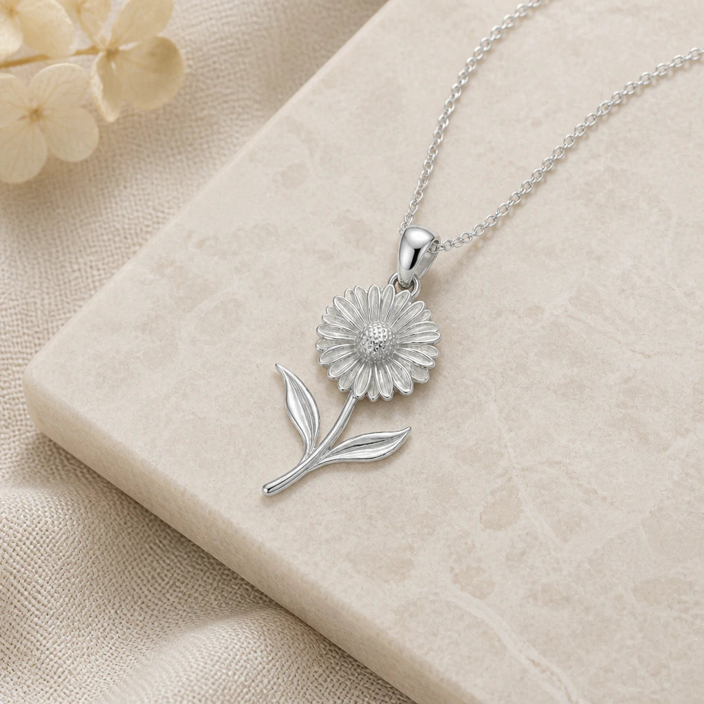 Close-up of silver calendula flower pendant showing the sculpted detail