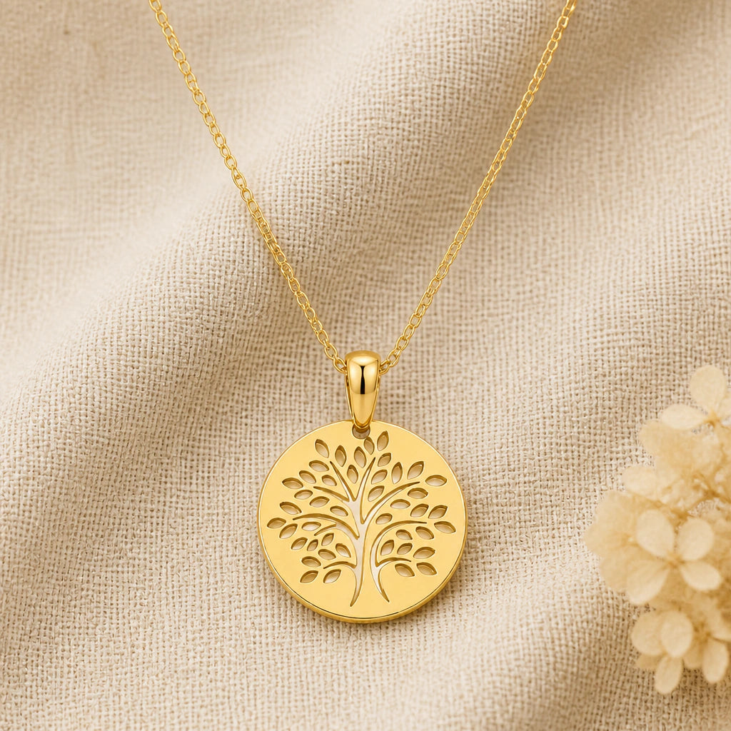 Tree of Life Disc pendant necklace in a warm gold finish on cream fabric