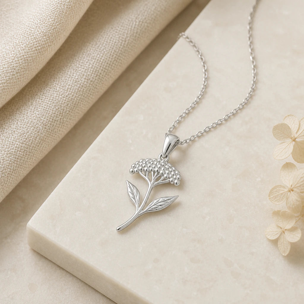 Close-up of silver yarrow flower pendant showing the sculpted detail