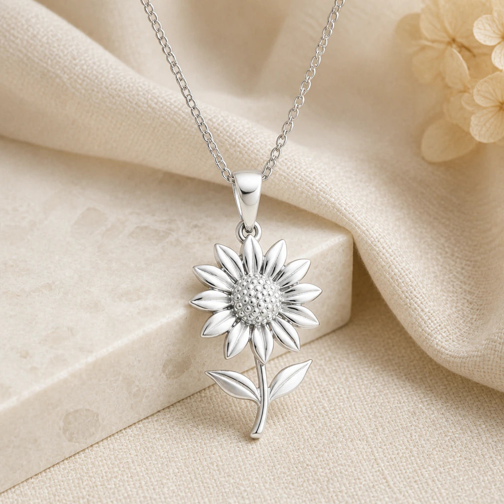 925 sterling silver sunflower pendant necklace on softly folded cream linen