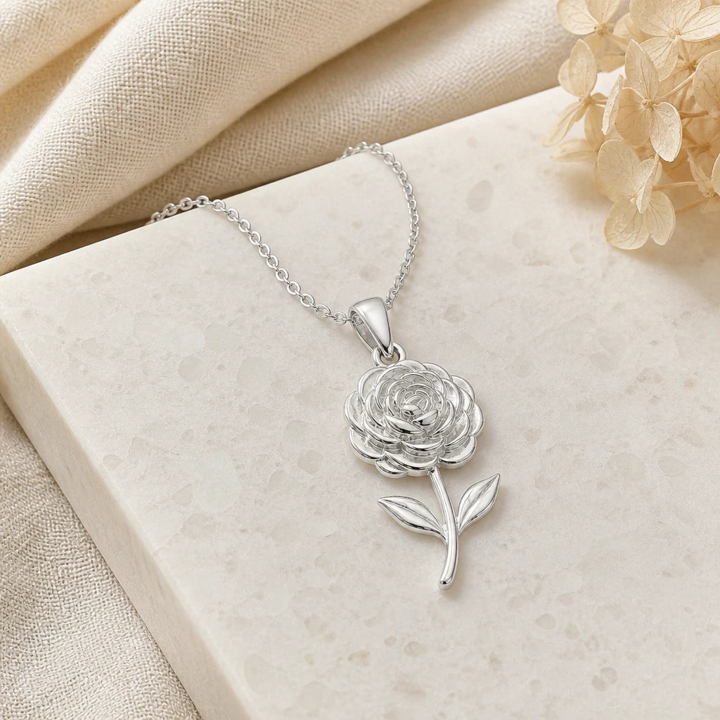 Close-up of silver ranunculus flower pendant showing the sculpted detail