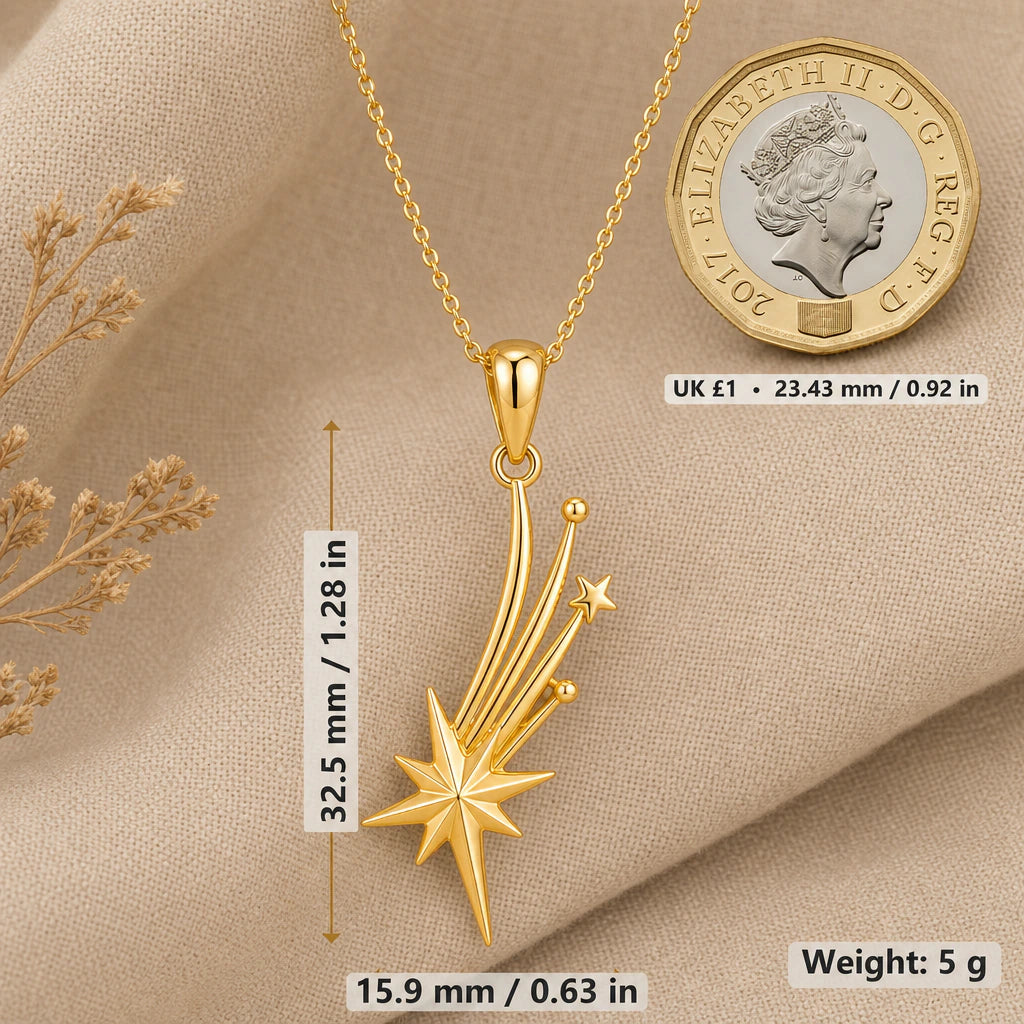 Falling star necklace size image showing 32.5 mm height, 15.9 mm width and 5 g weight beside a UK pound coin