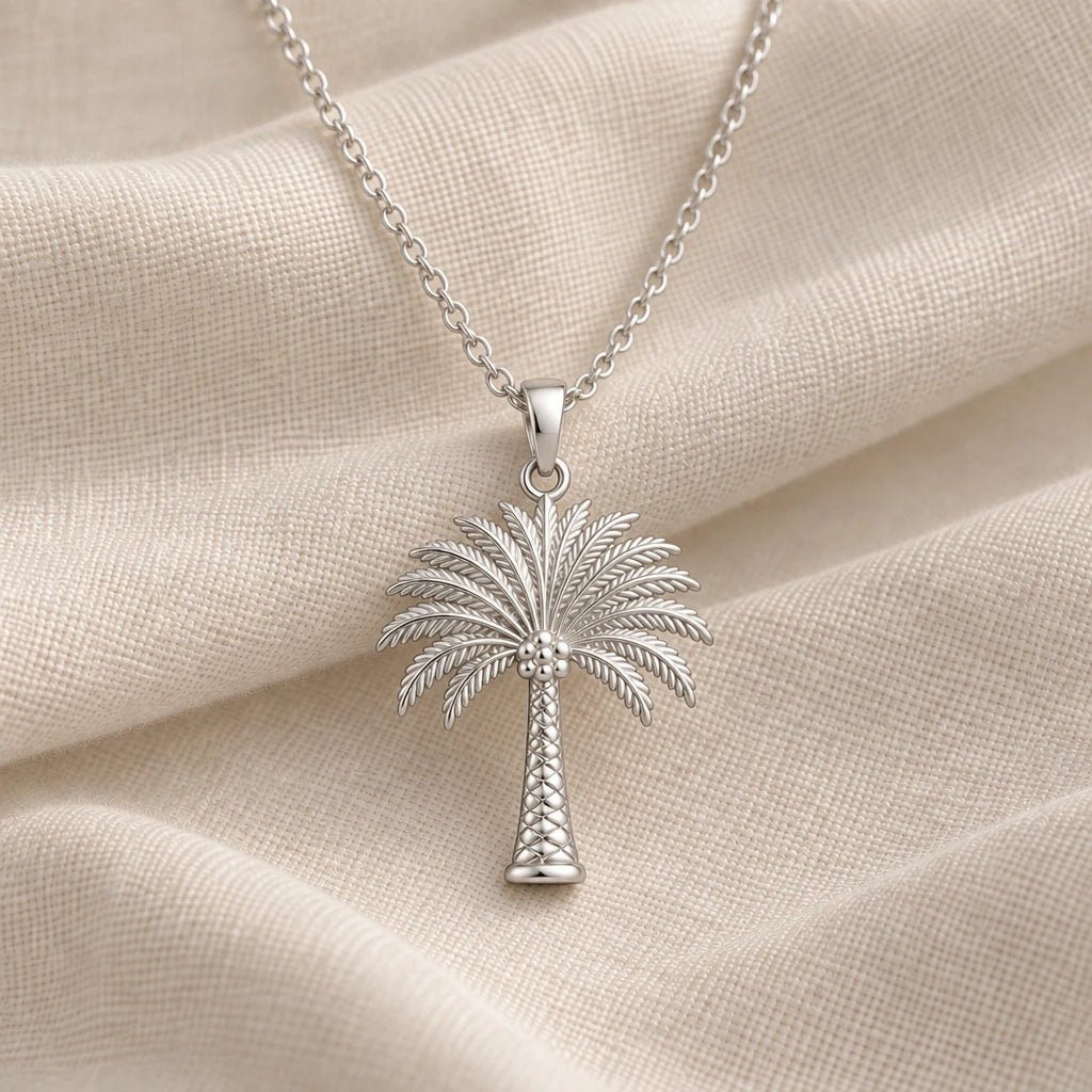925 sterling silver palm crown tree pendant necklace on cream fabric