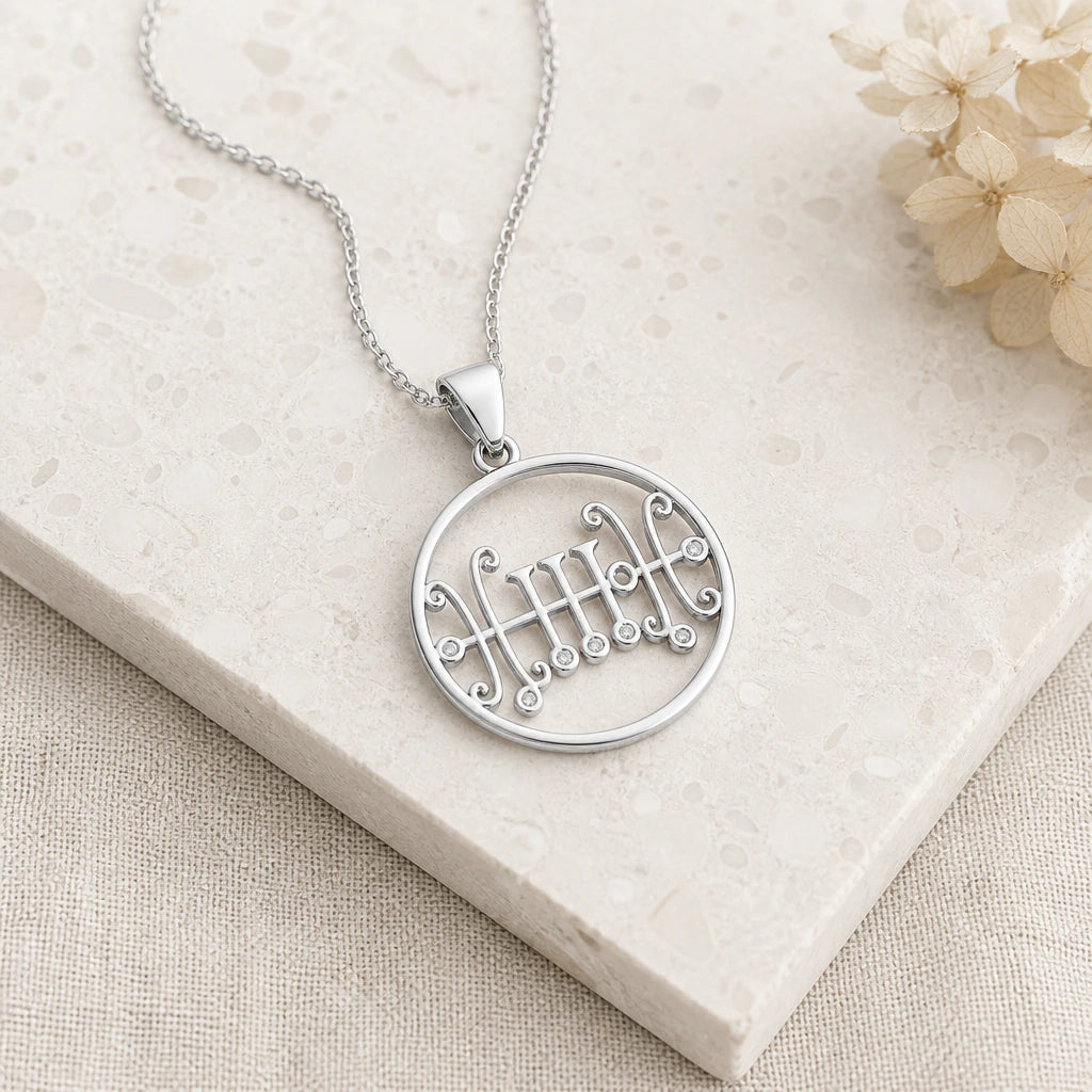 Close-up of silver seal of sallos birthstone pendant showing the sculpted detail