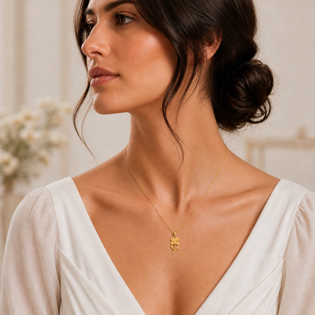 Impatiens flower pendant necklace worn by a woman, wider outfit view