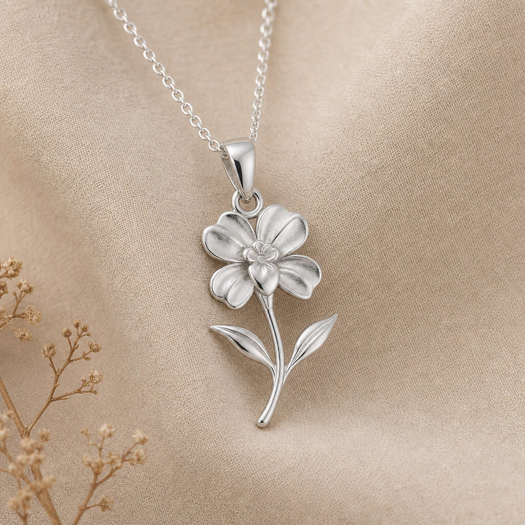 Impatiens flower pendant necklace in polished 925 sterling silver on cream linen