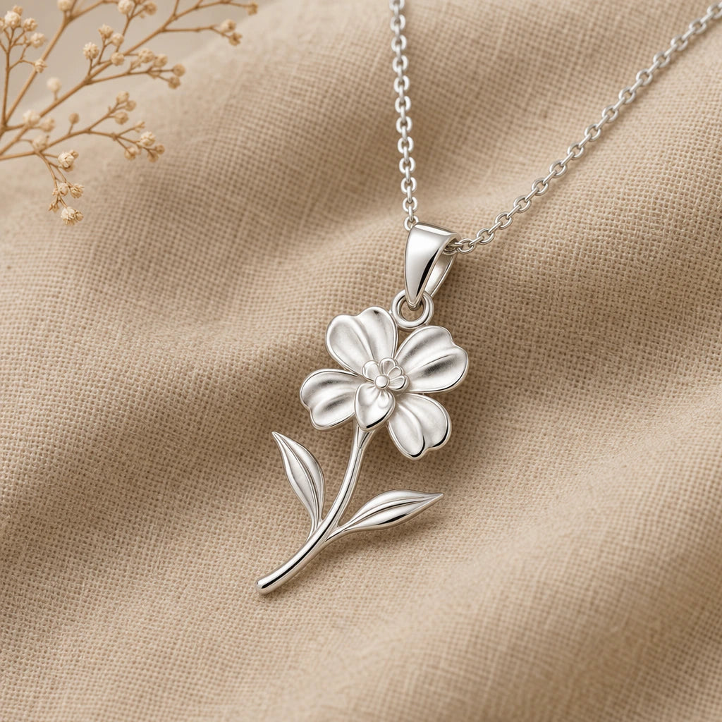 Close-up of silver impatiens flower necklace with sculpted petals, leaves and stem