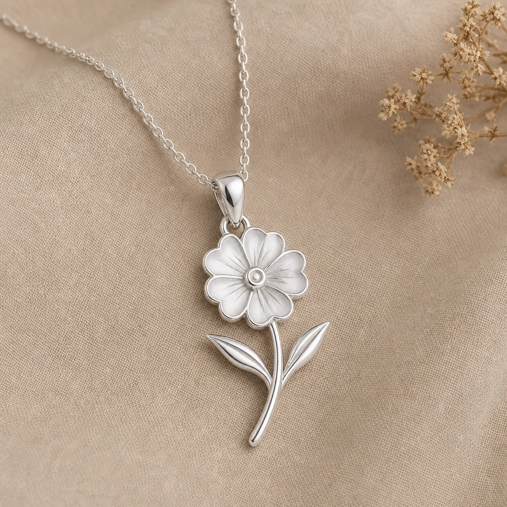 Primrose flower pendant necklace in polished 925 sterling silver on cream linen