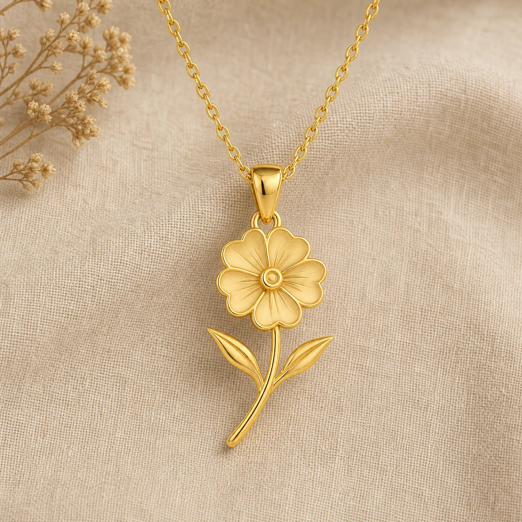 Primrose flower pendant necklace in gold finish on cream linen