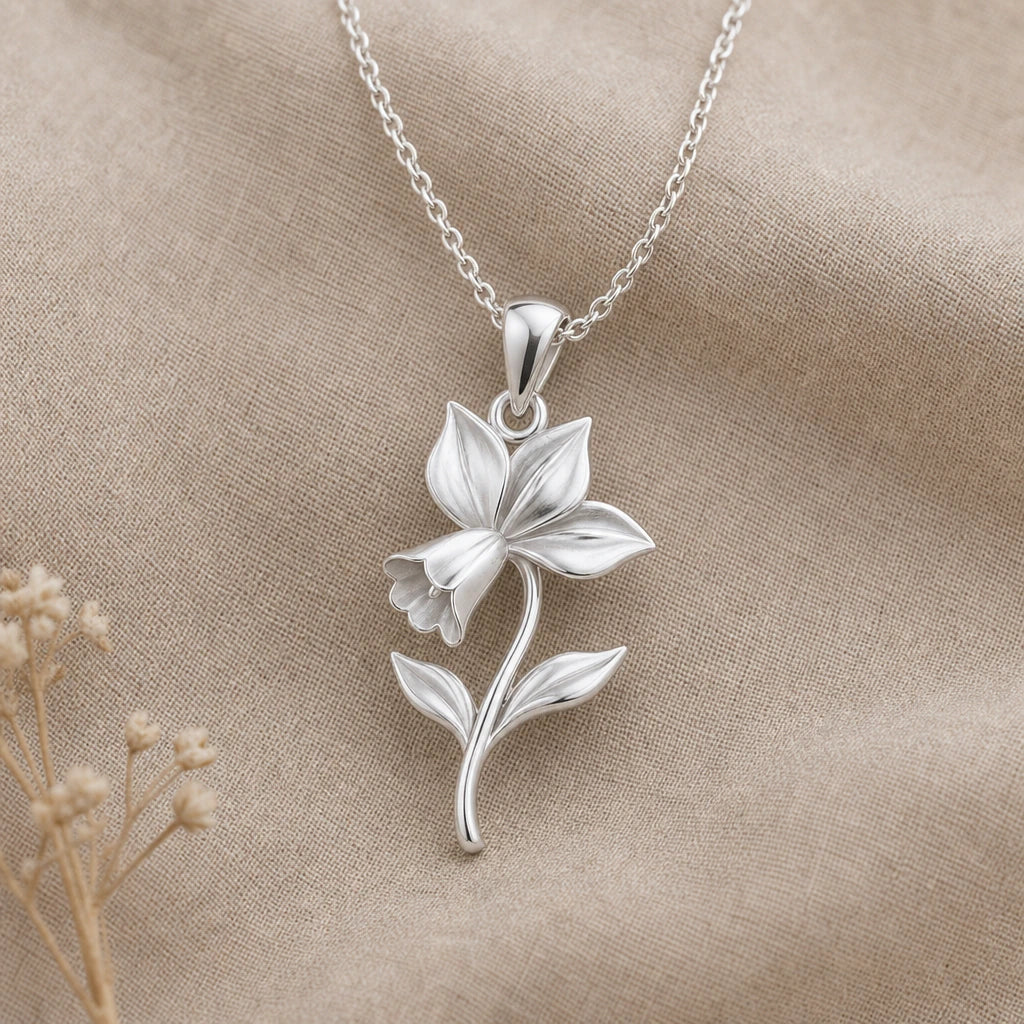 Cyclamen flower pendant necklace in polished 925 sterling silver on neutral linen