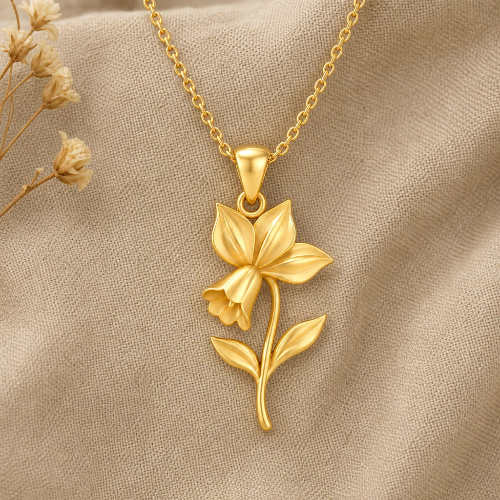 Cyclamen flower pendant necklace in gold finish on cream linen