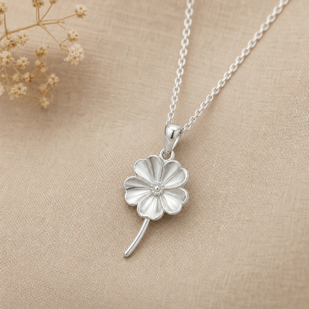 Silver forget me not flower pendant necklace in 925 sterling silver on beige linen