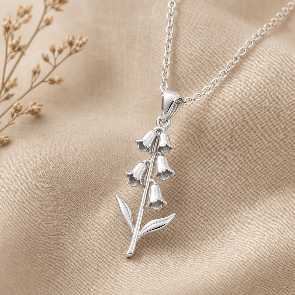 Close-up of silver foxglove pendant with five flared bells
