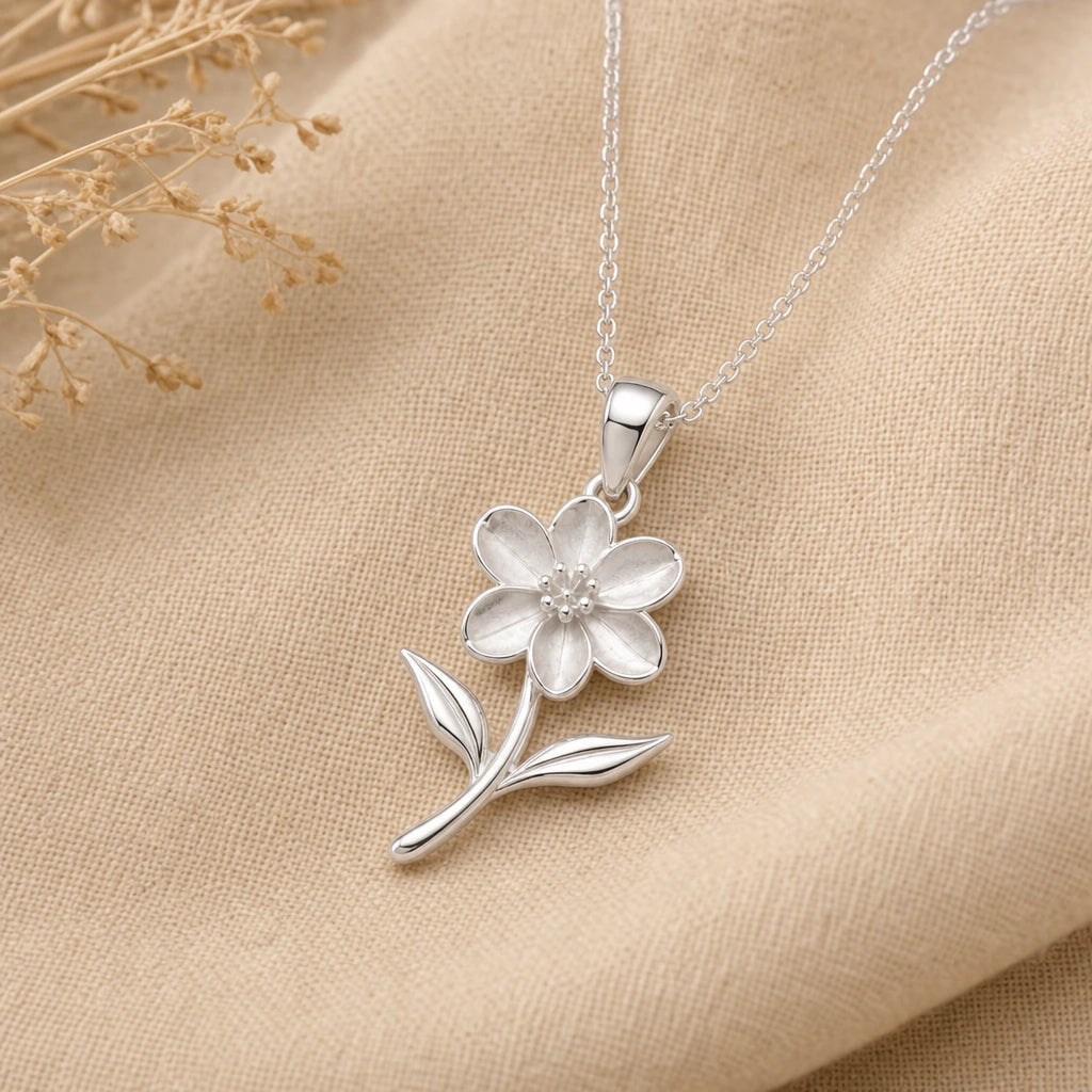 Close-up of silver jasmine pendant with six petals and two leaves
